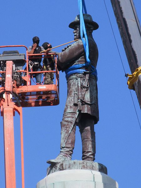 Workers preparing to remove a monument in New Orleans in April