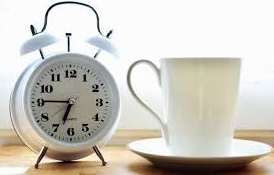Alarm clock and coffee mug.