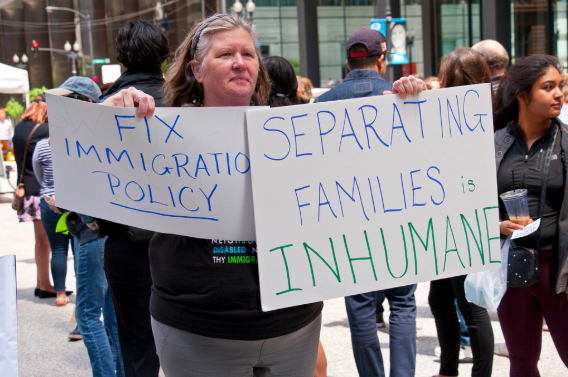 A women protests the Trump Administration's widely controversial immigration policy. -- Google Common License