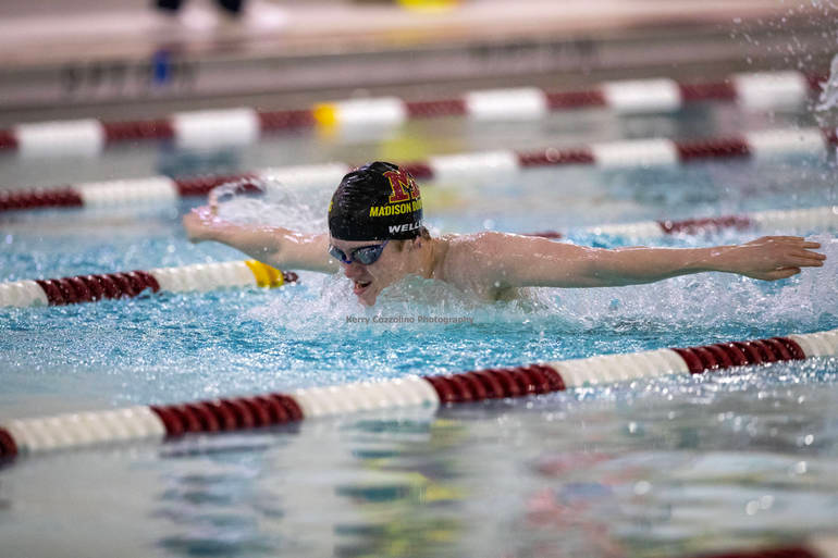Junior Owen Weller swims the 100-meter butterfly during the meet on January 12. 