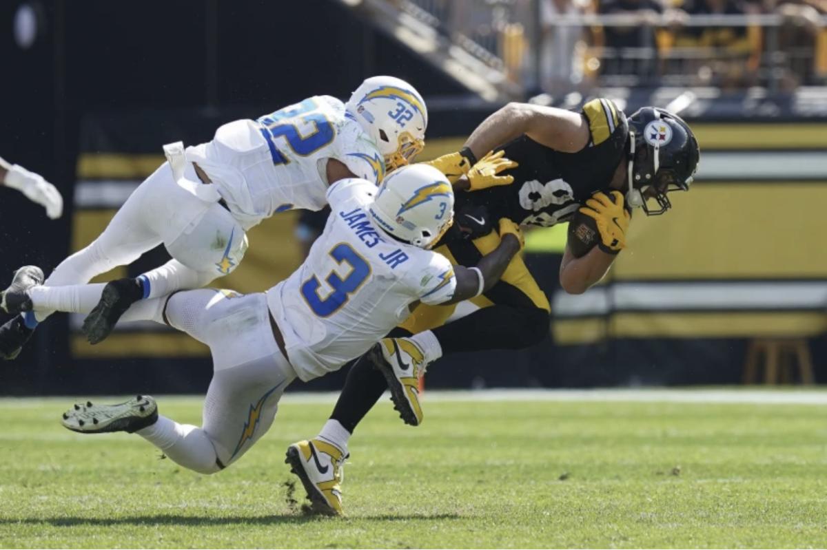 Los Angeles Chargers Safety, Derwin James, tackling Pittsburgh Steelers Tight End Pat Freiermuth.