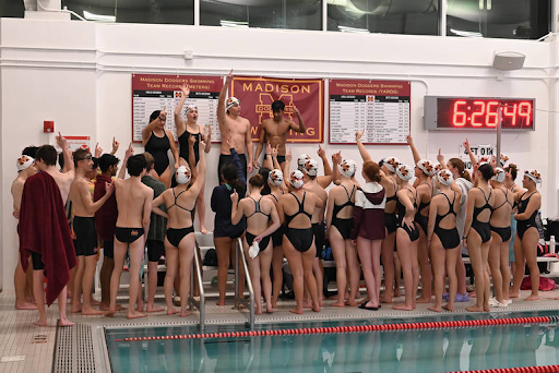 The Madison swim team captains lead a cheer.