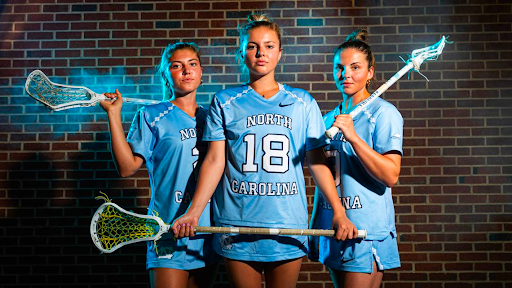 North Carolina lacrosse sisters Chloe Humphrey (2), Ashley Humphrey (18) and Nicole Humphrey (9) pose at Dorrance Field on the campus of UNC Friday, May 2, 2025